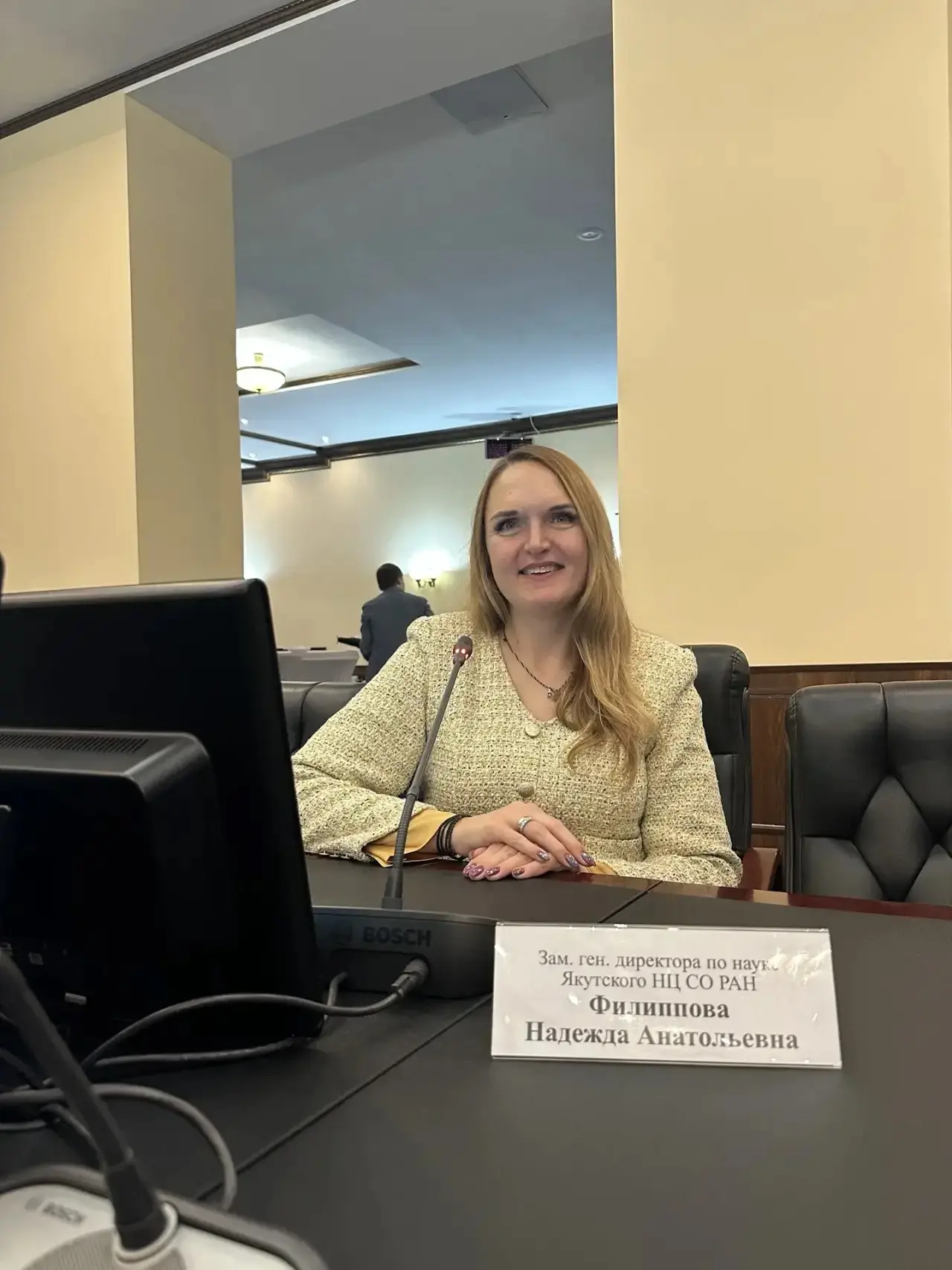 Nadezhda Filippova at a table with a nameplate indicating her position.